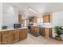 Modern kitchen with stainless steel appliances, wooden cabinetry, and ample counter space at 37334 N 17Th Ave, Phoenix, AZ 85086