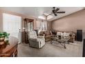 Cozy living room featuring a high vaulted ceiling, comfortable furniture, and natural light at 37334 N 17Th Ave, Phoenix, AZ 85086