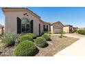 Lovely stucco home with desert landscaping, window shutters, and a two-car garage at 4229 E Nightingale Ln, Gilbert, AZ 85298