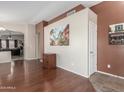Inviting living room with wood floors and an open layout offering a seamless transition into other living areas at 4817 W St Charles Ave, Laveen, AZ 85339