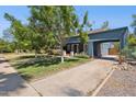 Charming home with mature trees, lush lawn, a gated carport, and vibrant landscaping at 530 W Willetta St, Phoenix, AZ 85003
