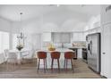 Bright kitchen with stainless steel appliances, a large island with bar seating and eat in dining at 6368 W Firebird Dr, Glendale, AZ 85308