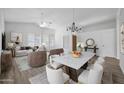 Airy living room and dining room featuring modern decor, neutral colors, and plenty of natural light at 6368 W Firebird Dr, Glendale, AZ 85308