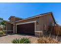 Single-story home with a two-car garage, stone accents, and low-maintenance landscaping at 7620 W Pioneer St, Phoenix, AZ 85043