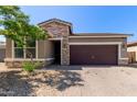 Charming single-story home with a two-car garage, stone accents, and low-maintenance landscaping at 7620 W Pioneer St, Phoenix, AZ 85043