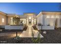 Stunning home exterior with modern architectural details, a pathway, and professionally landscaped grounds at 9441 N 129Th Pl, Scottsdale, AZ 85259