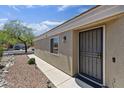 Inviting home entrance with a security door, desert landscaping, and accent lighting at 11330 W Eden Mckenzie Dr, Surprise, AZ 85378