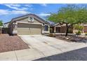 View of the well-maintained home with desert landscaping and a spacious driveway at 11330 W Eden Mckenzie Dr, Surprise, AZ 85378
