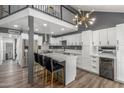 Modern kitchen with white cabinets, gray walls, quartz countertops, island with seating, and stainless steel appliances at 1174 E Belmont Ave, Phoenix, AZ 85020