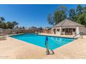 Community pool with sparkling blue water, lounge chairs and a shaded pool house at 1174 E Belmont Ave, Phoenix, AZ 85020