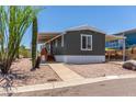 Inviting home with a carport and new wood stairs, complimented by desert surroundings at 12811 N 19Th Pl, Phoenix, AZ 85022
