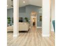 Spacious living area with high ceilings, neutral tones, and smooth flooring flowing into the hallway at 136 E Vera Ln, Tempe, AZ 85284