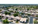 Expansive aerial view of the neighborhood showcasing lush landscaping and a picturesque golf course in the background at 1711 W Houston Ave, Gilbert, AZ 85233