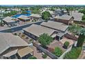 Community aerial view featuring well-maintained homes with desert landscaping, tile roofs, and community lake at 1741 S Clearview Ave # 13, Mesa, AZ 85209