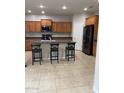 Well-appointed kitchen featuring a center island with seating, stainless steel appliances, and ample cabinet space at 2018 W Marconi Ave, Phoenix, AZ 85023