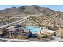 Beautiful community pool with lounge chairs and seating, set against a mountain backdrop at 21297 W Edgemont Ave, Buckeye, AZ 85396