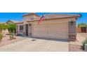 Attractive single-story home with a two-car garage, desert landscaping, and a well-maintained front yard at 22543 W Cocopah St, Buckeye, AZ 85326