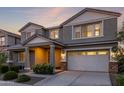 Exterior home showcasing architectural details, including a two-car garage and inviting front entrance at 23042 E Excelsior Ave, Queen Creek, AZ 85142
