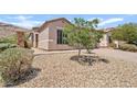 Desert landscaping and a beautiful stone pillar accentuates the front exterior of this single story home at 3026 W Silver Fox Way, Phoenix, AZ 85045