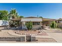 Charming single-story home featuring desert landscaping and covered parking at 3239 E Kings Ave, Phoenix, AZ 85032