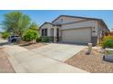 Charming single-story home featuring a two-car garage, neutral stucco, desert landscaping, and a welcoming front door at 3715 S 57Th Ln, Phoenix, AZ 85043