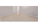 A bedroom with tile flooring and a neutral wall color. Bathroom access through door at 3722 W Hadley St, Phoenix, AZ 85009