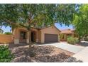 Charming two-story home with a two car garage, surrounded by mature trees and lush landscaping at 4051 E Torrey Pines E Ln, Chandler, AZ 85249