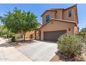 Attractive two-story home featuring a two car garage and lush landscaping at 4051 E Torrey Pines E Ln, Chandler, AZ 85249