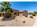 Attractive single-story home with easy-care desert landscape design and a convenient two-car garage at 43581 W Mccord Dr, Maricopa, AZ 85138