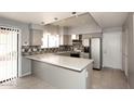 Bright kitchen boasts granite countertops, mosaic backsplash, stainless appliances, and eat in bar at 4437 E Villa Theresa Dr, Phoenix, AZ 85032