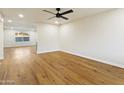Spacious living room with hardwood floors and a modern ceiling fan at 4611 E Fremont St, Phoenix, AZ 85042