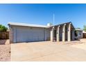 Exterior of single story home featuring a two-car garage and a covered front entry with desert landscaping at 4740 W Bloomfield Rd, Glendale, AZ 85304