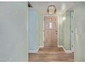 Inviting entryway with new flooring, fresh paint, and modern lighting fixture at 5204 E Colby St, Mesa, AZ 85205