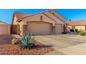 Charming single-Gathering home featuring a three-car garage, desert landscaping, and great curb appeal at 5524 E Garnet Cir, Mesa, AZ 85206