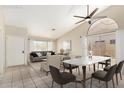 Staged living room with dining area, with neutral decor, large windows, and contemporary furnishings at 6317 E Colby St, Mesa, AZ 85205