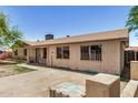 Single-story home featuring desert landscaping, a small tree, and a wide driveway at 6426 W Mulberry Dr, Phoenix, AZ 85033