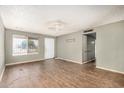 This spacious living room boasts wood floors, neutral walls, a large window, and a ceiling fan at 6426 W Mulberry Dr, Phoenix, AZ 85033