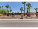 Single-story home with desert landscaping, mature palm trees, and a quaint entryway at 7101 E Cholla St, Scottsdale, AZ 85254