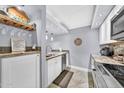 Bright kitchen featuring white cabinets, granite countertops, stainless steel appliances, and a wine rack at 7625 E Camelback Rd # B138, Scottsdale, AZ 85251