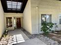 Inviting front entry with wood door, desert landscaping and large picture windows at 8947 N 84Th Way, Scottsdale, AZ 85258