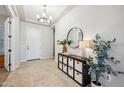Bright foyer with neutral tones, decorative mirror, and ample storage at 10322 E Topaz Ave, Mesa, AZ 85212