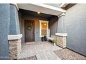 Inviting front porch with stone pillars, decorative door, and welcoming decor at 10322 E Topaz Ave, Mesa, AZ 85212