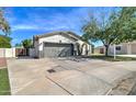 Inviting home with a well-maintained front yard, driveway, and two-car garage at 10402 E Javelina Ave, Mesa, AZ 85209