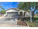 Beautiful home with manicured lawn, two-car garage, and inviting front entrance at 10402 E Javelina Ave, Mesa, AZ 85209