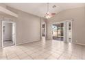 Bright living room featuring tile floors, neutral walls, and sliding glass doors to backyard at 10923 W Ivory Ln, Avondale, AZ 85392