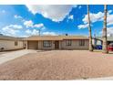 A charming single-story home with a gravel front yard, a carport, and two mature palm trees at 1512 W Crescent Ave, Mesa, AZ 85202
