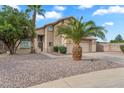 Desert landscaped home featuring a two car garage, and gated front entry at 1574 E Scott Ave, Gilbert, AZ 85234
