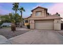 Two-story home featuring a two-car garage, desert landscaping, and a red tile roof at 1574 E Scott Ave, Gilbert, AZ 85234