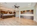 Open-concept living room and gourmet kitchen featuring modern wood floors at 16729 W Alvarado Dr, Goodyear, AZ 85395