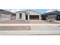 Inviting single-story home featuring a brick driveway and a two-car garage with eye-catching, contrasting trim at 18262 W La Senda Dr, Surprise, AZ 85387